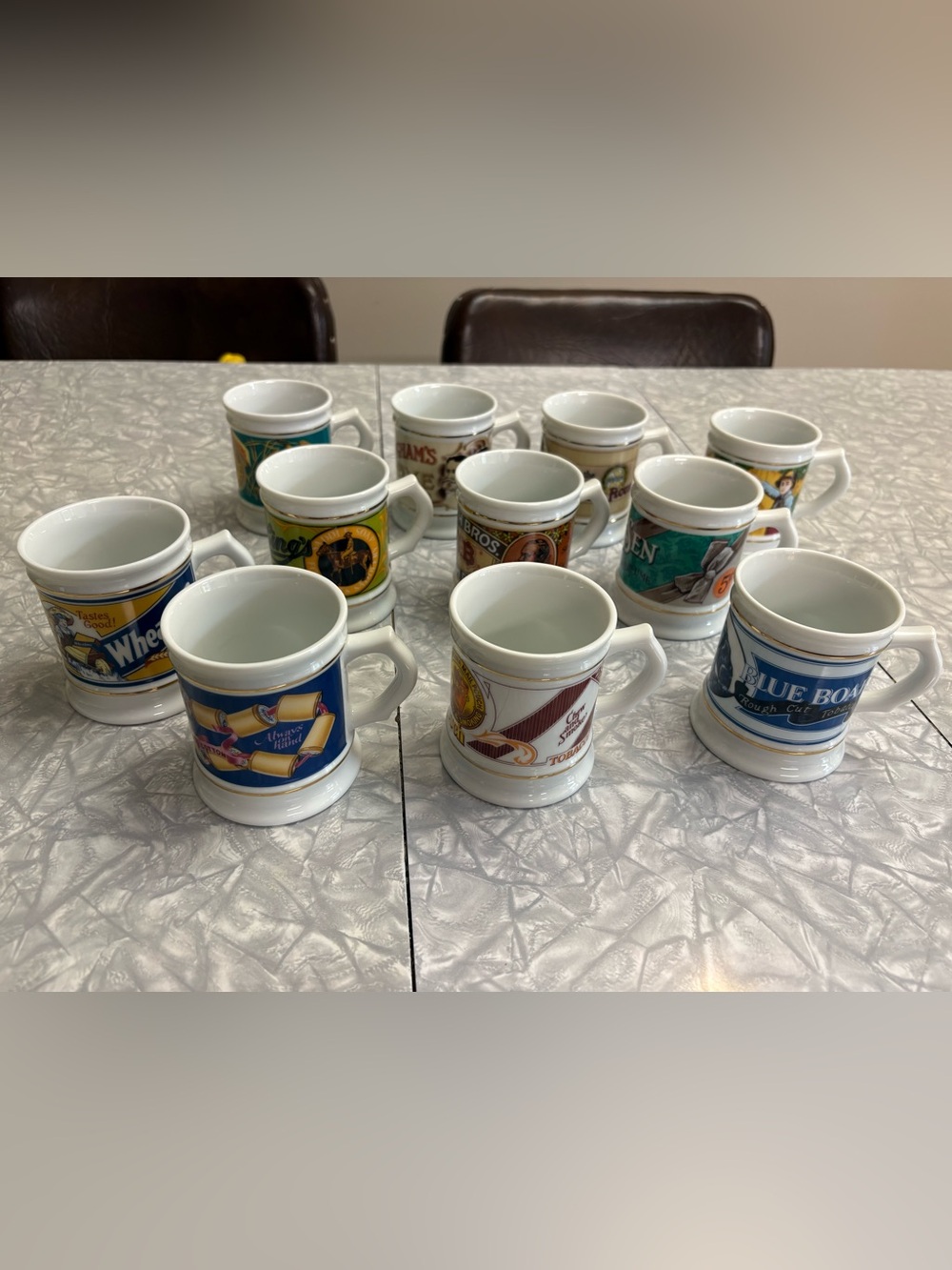 Set of 11 The Corner Store Collectible porcelain Logo Mugs.